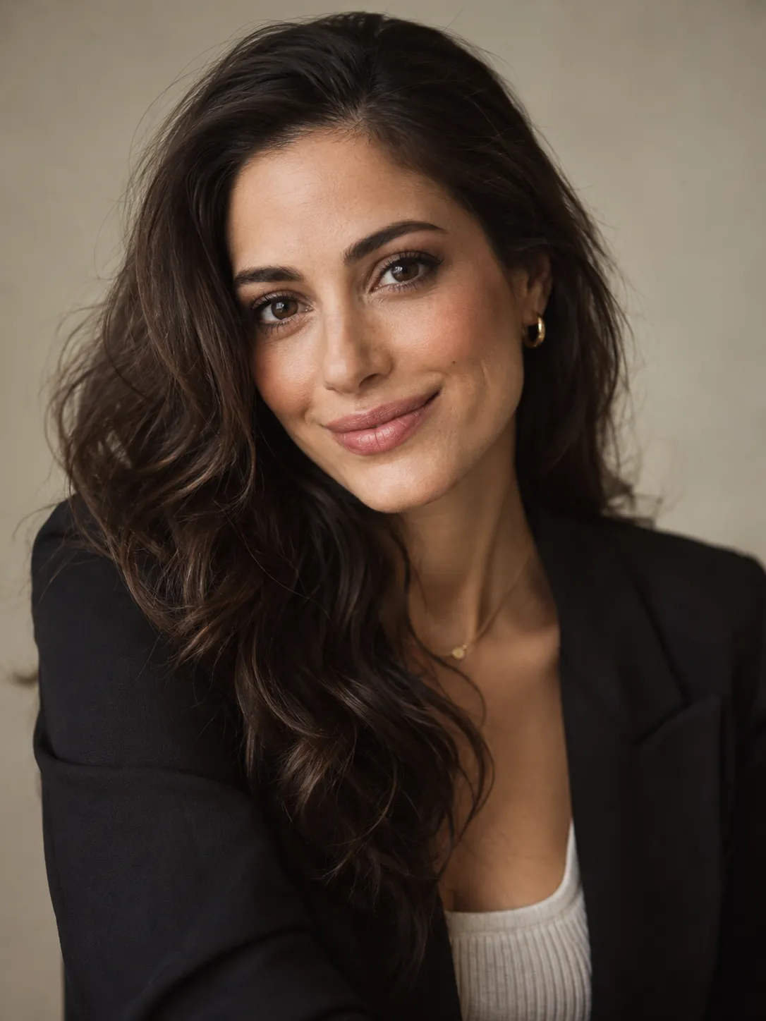 Portrait of Sophia smiling, wearing a black blazer